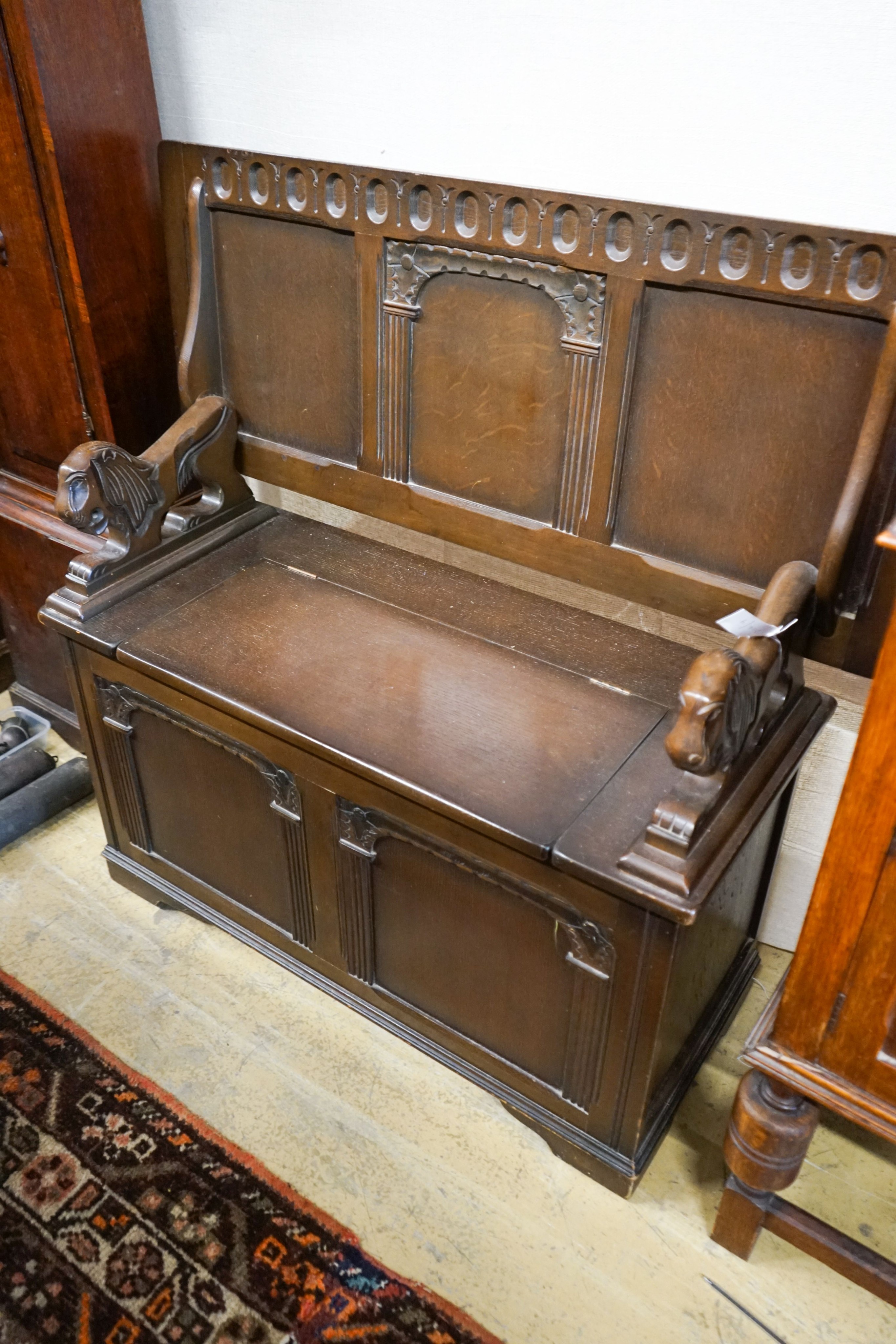 An 18th century style oak monks bench together with a 1920's oak sideboard